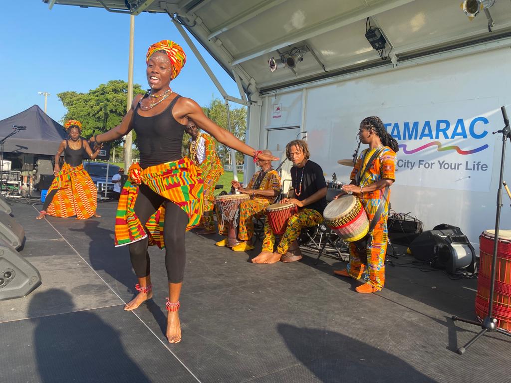 Woman dancing draped in colorful clothing 